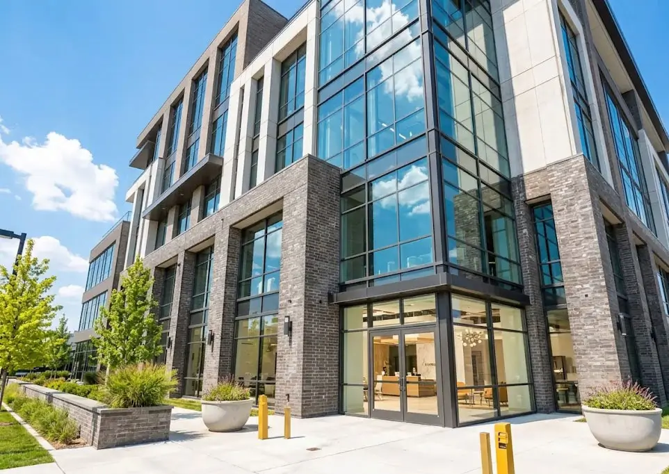 Exterior view of a multi-story mixed-use commercial building on a vibrant downtown street corner in DuPage County, featuring ground-floor retail storefronts and upper-level office space.